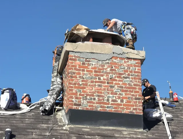 Plainville Chimney Sweep installing a custom chimney crown in Plainville, CT