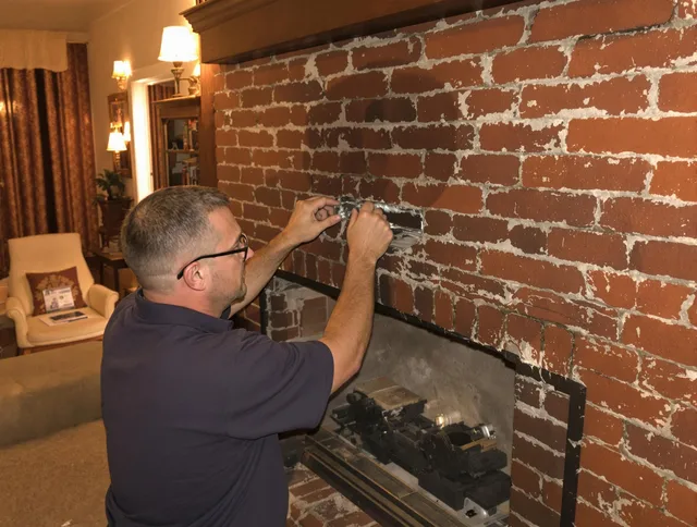 Plainville Chimney Sweep expert fixing a fireplace in Plainville, CT